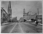 Commerce Street, Dallas, Texas with street car on tracks and man walking beside a pony by Squire Haskins Photography Inc.