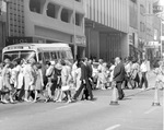 Downtown Dallas, Texas crowds crossing street in front of city bus by Squire Haskins Photography Inc.