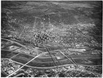 Aerial looking north of the Trinity River, an industrial area and downtown Dallas, Texas by Squire Haskins Photography Inc.