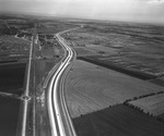 An airview of highway with field to the right - Central and Arapaho, Richardson, Texas by Squire Haskins Photography Inc.