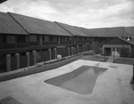 English Village apartment building, exterior outdoor pool by Squire Haskins Photography Inc.