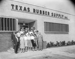 Texas Rubber Supply, Inc. building with employees gathered outside by Squire Haskins Photography Inc.