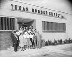 Texas Rubber Supply, Inc. building with employees gathered outside by Squire Haskins Photography Inc.