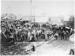 Wagon train carrying cotton pulled by eight horses
