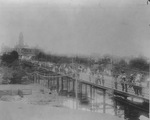 People standing on the old wire bridge that crosses the Trinity River north of the Tarrant County Courthouse