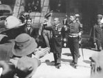 Mexican Revolution, two military officers wearing medals walking through crowd of men