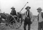 A Woman on a wagon with flag furled on back and two rebel soldiers