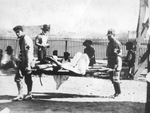 Red Cross workers carrying stretcher with wounded Mexican soldier