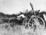 A Mexican soldier firing cannon-like gun and similar gun nearby with other soldier