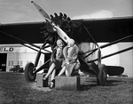 Two women sitting next to a Texas Air Transport Passenger Ship