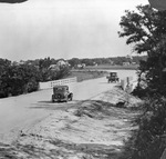 Car and truck driving on country road