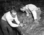 Joseph W. Gauci and Salvatore Gauci setting up "Holy Land" exhibit