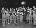 Lulu Bates with Billy Rose's "Jumbo" performers and the Pioneer Palace Band inside the Pioneer Palace during the Frontier Centennial