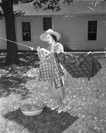 Mrs. Paul Whiteman hanging clothes on clothesline, 1936