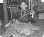 Wife of Hastin Acani, a Navajo Indian woman, spins thread from raw wool at Fort Worth Frontier Centennial