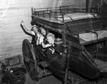 Fort Worth Frontier Centennial show girls inside an old stage coach