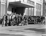 Will Rogers and Amon G. Carter among a crowd of people with a motor escort