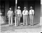 Amon G. Carter and three other men standing in front of a hotel