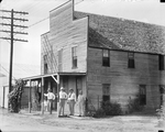 Amon G. Carter and three other men standing in front of a hotel