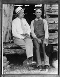 Amon Carter and man wearing overalls