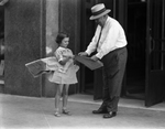 Ruth Carter selling newspapers