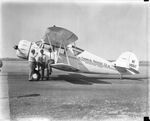 Oil producers Paul W. Pitzer and C. K. West with F. G. Rhenstrom next to WACO biplane