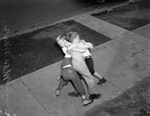 C. J. Reed, center, and Douglas Higgins, left rear, tussle with Alvin Adams and Fred Galbiati