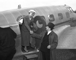 Sally Rand, dancer, stepping from plane at Fort Worth's Municipal Airfield (Meacham Field)