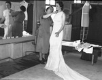 Mrs. Irma Luce fitting Faye Cotton with muslim version of gold mesh gown