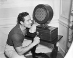 Max Baer listening to a radio