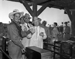 John Nance Garner at the entry gates for the Frontier Centennial, with Sherman Minton and Amon G. Carter
