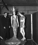 Tilda Goetze in silver gown; J. F. Pollock, left, and Lauretta Jefferson considering costumes for Casa Manana revue at Frontier Fiesta