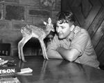 Forest Park Zoo's zookeeper Hamilton Hittson with tiny fawn