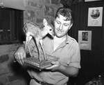 Forest Park Zoo's zookeeper Hamilton Hittson with tiny fawn