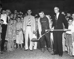 County Commissioner Joe Thannisch lifting first shovel of dirt at groundbreaking ceremonies on East Lancaster Avenue, Fort Worth
