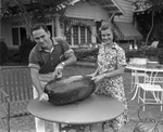 Amon G. Carter Jr. and Ruth Carter cutting watermelon