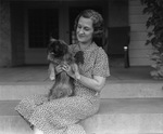 Mrs. Amon G. Carter with dog at Carter residence
