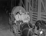 Fort Worth Fall Horse Show and Community Circus; in prairie schooner on wagon seat, from left, Charlie Woods, Mrs. Bob Meyer, and Mrs. Al Wilson; Elizabeth Ann Wilson, standing, 11/1937