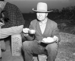 Jim Gilmore eating meal at chuck wagon on Spur Ranch