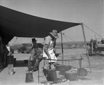 Cook making at meal at chuck wagon on Spur Ranch