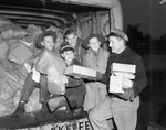 From left, Lena Pope Home boys, Leroy Ross, Euler Phillips, Randall High, and Carl Pickle, with W.L. Hooks, driver for Binyon-O'Keefe, help deliver Goodfellows' Christmas bags, 12/22/1937