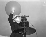 Roland Mills, assistant weather observer, releasing a balloon to determine wind direction and velocity