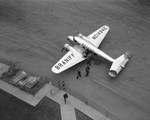 Braniff Airlines airplane unloading passengers in front of the terminal at Fort Worth Municipal Airport