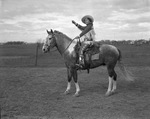 Tad Lucas, rodeo performer, astride horse