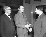 Winfield Scott of Fort Worth (right), with attorney Albert Baskin, surrenders to Sheriff Carter on charges of contempt of Dallas district court for failing to make alimony payments