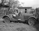 Rudolph Dolkos in seat of his old Chalmers "racer" which will be an entry in "the old car contest" at the Spring Automobile Show