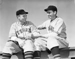 Lefty Clyde Smoll, left, pitcher for Fort Worth Cats, lets Cats player Jimmy M. Leod feel his arm