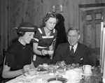 Leola Thomas, Hotel Texas waitress (center), serves Margaret Day Trigg and Ed P. Williams