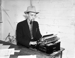 E.D. Alexander, publicity director for the Southwestern Exposition and Fat Stock Show, at typewriter