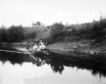 Beaumont Sea Scouts round bend in Trinity River; Capt. Dean Tevis, Beaumont newspaperman, stands in boat, 07/08/1938